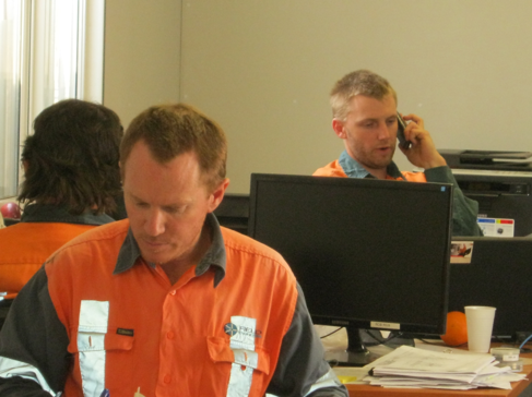 Office-based forensic engineering team analysing project reports at Field Engineers